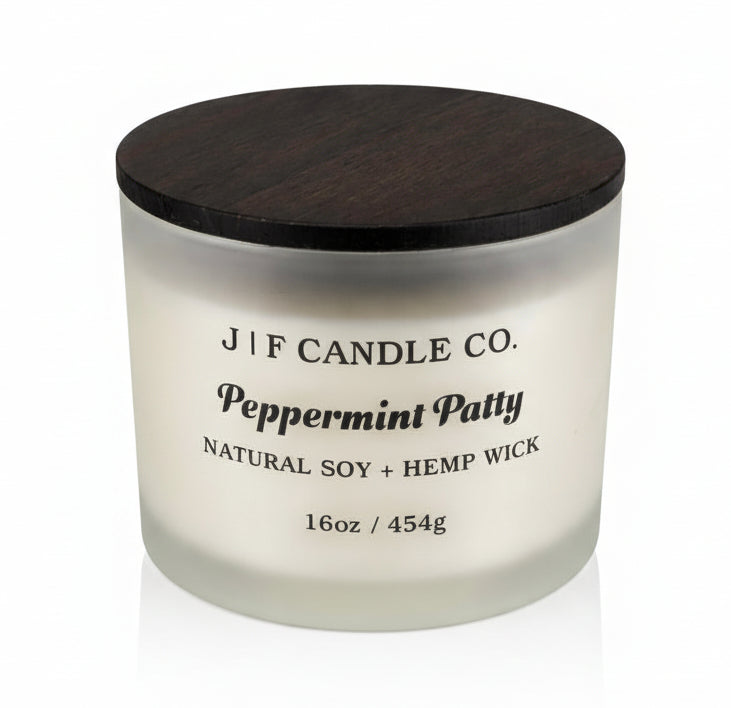 J | F Candle Co Peppermint Patty 16oz soy candle in frosted glass jar with wooden lid, clean white background with soft reflection, mint chocolate fragrance candle
