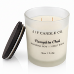 J | F Candle Co. Pumpkin Chai 12 oz frosted glass soy candle with black wooden lid placed beside the jar on a clean white background with a soft reflection.