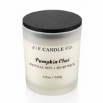 J | F Candle Co. Pumpkin Chai 12 oz frosted glass soy candle with black wooden lid on a clean white background with a soft reflection.