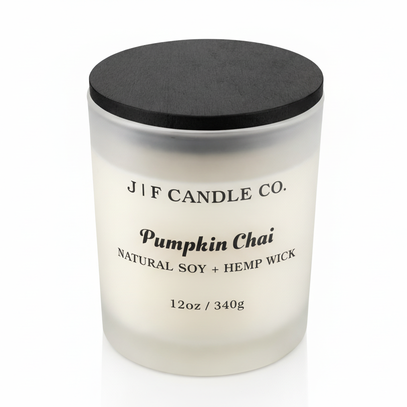 J | F Candle Co. Pumpkin Chai 12 oz frosted glass soy candle with black wooden lid on a clean white background with a soft reflection.