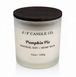 J | F Candle Co Pumpkin Pie 12oz luxury soy candle in frosted glass jar with wooden lid on clean white background with soft reflection