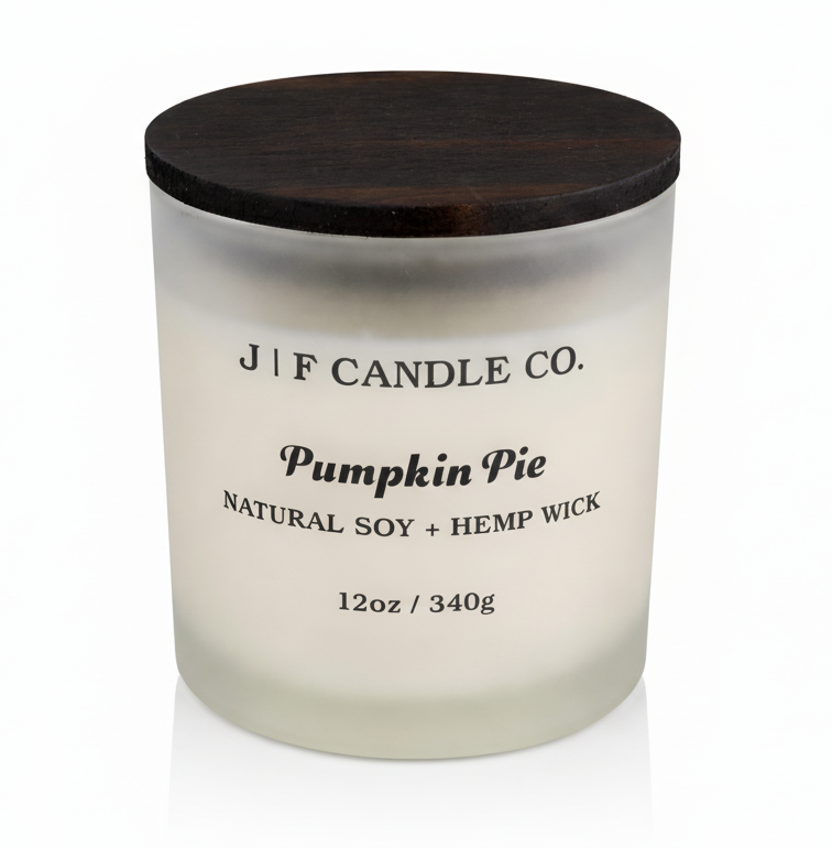 J | F Candle Co Pumpkin Pie 12oz luxury soy candle in frosted glass jar with wooden lid on clean white background with soft reflection