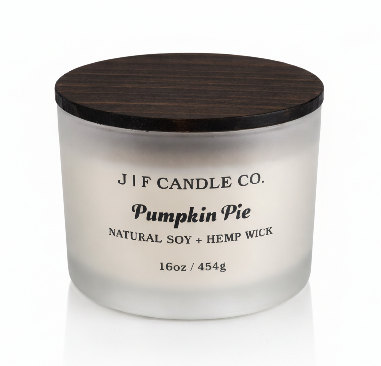 J | F Candle Co Pumpkin Pie 16oz luxury soy candle in frosted glass jar with wooden lid and soft reflection, clean minimalist product photo