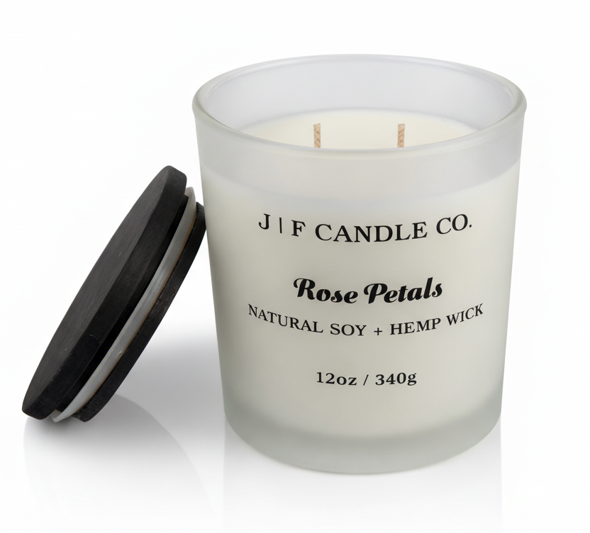J | F Candle Co Rose Petals 12oz luxury soy candle in frosted glass jar with wooden lid beside it, clean product photo with soft reflection and no website text