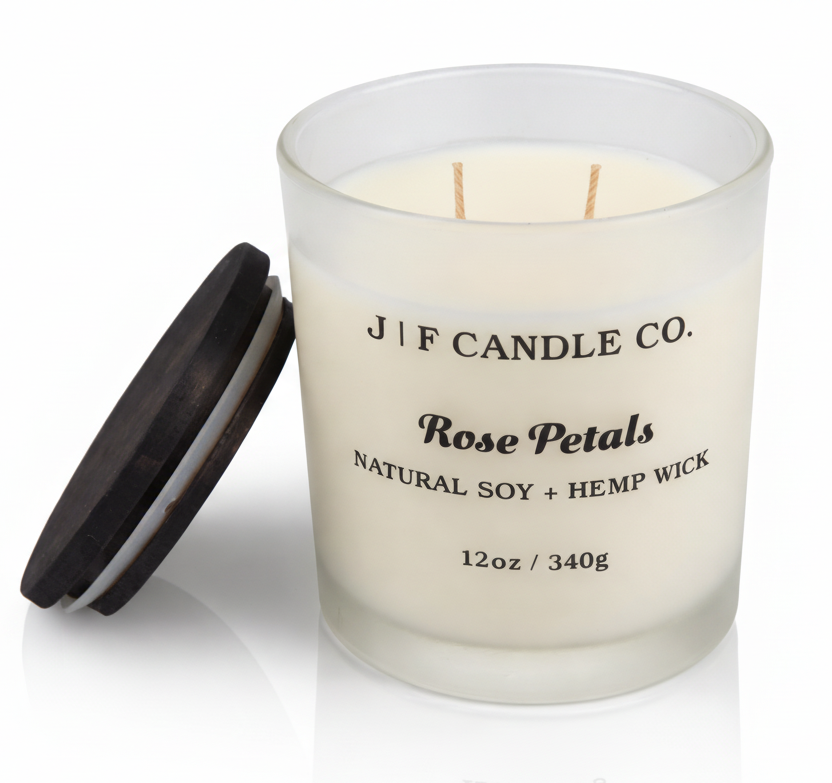 Rose Petals soy candle by J | F Candle Co in a frosted glass jar with wooden lid beside candle, clean burning natural soy wax with soft reflection on white background