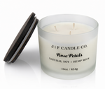 J | F Candle Co Rose Petals 16oz luxury soy candle with triple wicks in frosted glass jar and wooden lid beside it, clean product photo with soft reflection