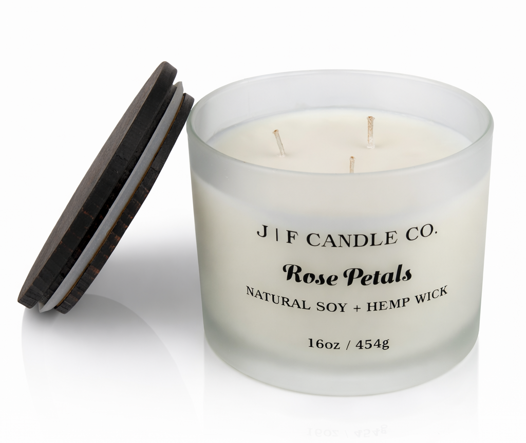 J | F Candle Co Rose Petals 16oz luxury soy candle with triple wicks in frosted glass jar and wooden lid beside it, clean product photo with soft reflection
