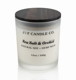 Luxury Sea Salt & Orchid soy candle by J | F Candle Co in a frosted glass jar with wooden lid, clean burn natural soy wax with soft reflection on white background