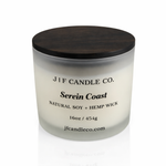 16 oz Serein Coast soy candle in a frosted glass jar with wooden lid on a white background with soft reflection, by J | F Candle Co.