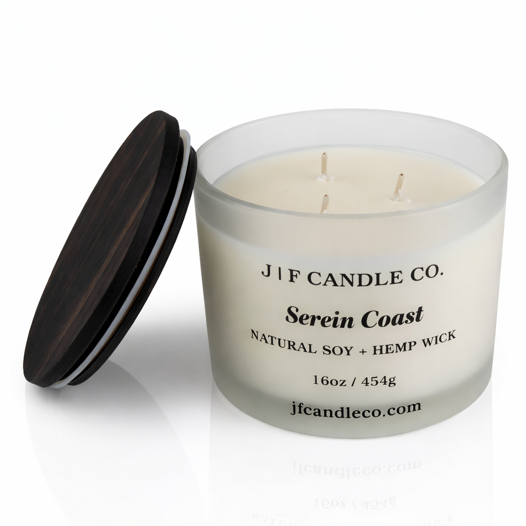 Open 16 oz Serein Coast soy candle with three hemp wicks in a frosted glass jar with wooden lid beside it on a white background with soft reflection, by J | F Candle Co.
