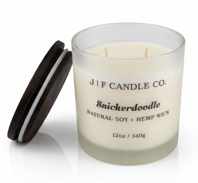 Luxury Snickerdoodle soy candle by J | F Candle Co. in frosted glass jar with wood lid beside candle, 12 oz clean-burning candle with soft reflection