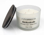 Luxury Snickerdoodle soy candle by J | F Candle Co. in frosted glass jar with wood lid beside candle, 16 oz clean-burning candle with soft reflection