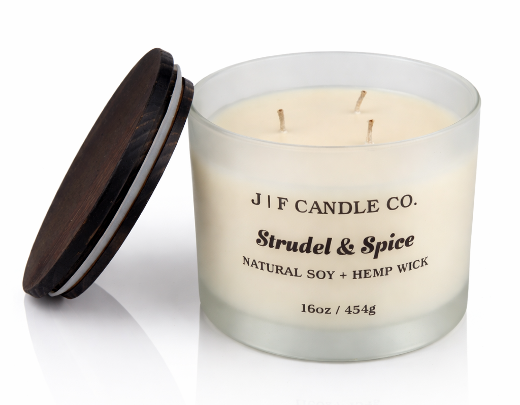 Strudel & Spice soy candle by J | F Candle Co in frosted glass jar with wooden lid and three wicks, 16 oz clean product photo with soft reflection