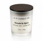 J | F Candle Co. Strudel & Spice soy candle in frosted glass jar with wooden lid, clean white background and soft reflection for luxury product display