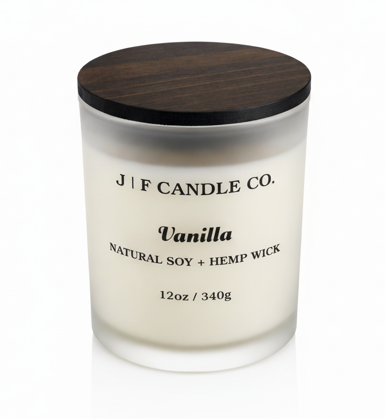 J F Candle Co Vanilla soy candle in frosted glass jar with wooden lid and soft reflection, clean white background luxury candle product photo