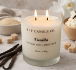 Vanilla soy candle by J | F Candle Co with lit wick, styled with vanilla beans, sugar cubes, and soft neutral spa-inspired background