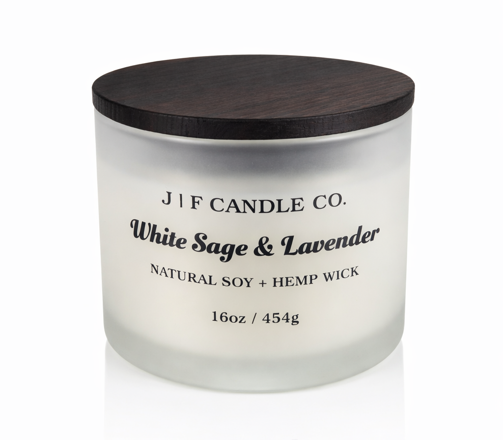 White Sage & Lavender 16 oz soy candle by J | F Candle Co. in frosted glass jar with wooden lid, clean white background with soft reflection, hand-poured luxury candle
