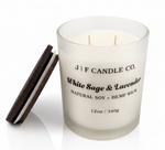 White Sage & Lavender soy candle by J | F Candle Co. in frosted glass jar with wooden lid beside it, clean white background with soft reflection, hand-poured luxury candle